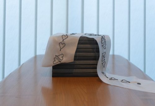 pile of books draped with a silk