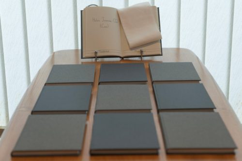nine books laid out on a table